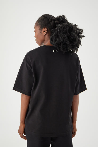 Women wearing black boxy t-shirt back view